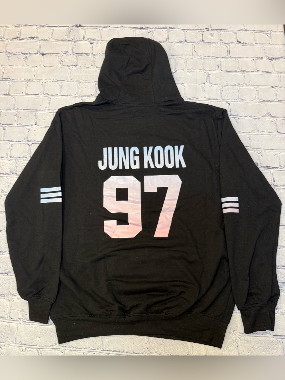 The BTS "Love Yourself" K-Pop Tour Hoodie features the iconic BTS logo